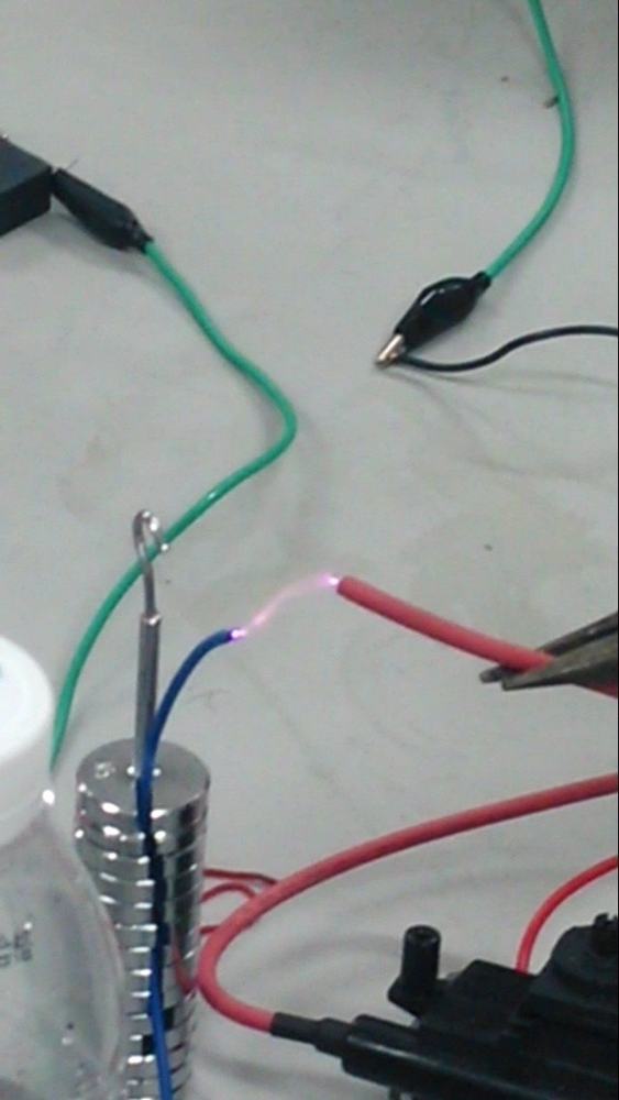 Small Tesla coil throwing visible high-voltage arcs