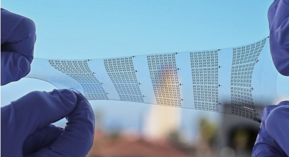 Stretchable circuit held between gloved hands